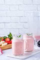 Pink smoothie with banana and strawberry for healthy, vegan diet