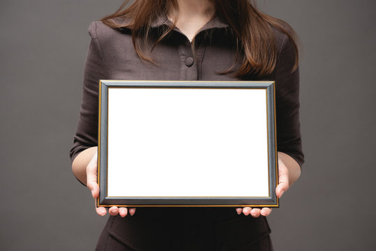 Blank diploma certificate mockup. Woman with empty photo frame with copy space close up.