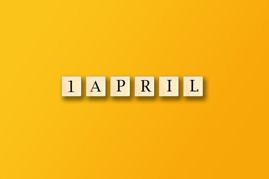 april foos day with wood on yellow background