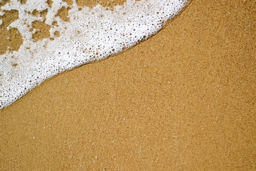 texture of sand and sea foam on the black sea beach, copy space