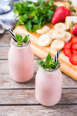 Pink smoothie with banana and strawberry for healthy, vegan diet