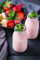Pink smoothie with banana and strawberry for healthy, vegan diet