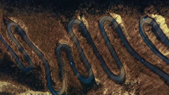 Scenic curvy road seen from a drone in autumn. Emilia Romagna, Italy