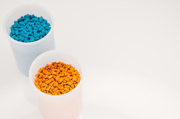 Plastic granules close up for holding,Colorful plastic granules with white background. and dollar money,Plastic Business,Plastic industry.