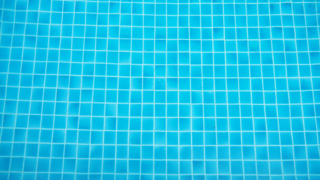 Closeup swimming pool with flow water wave and bottom surface texture and see top view using for background or banner summer concept.