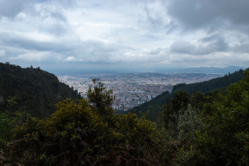 Bogotá, Colombia landscape in cloudy blu sky viewed from cerros orientales or eastern hills with...
