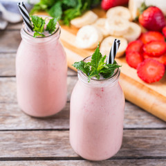 Pink smoothie with banana and strawberry for healthy, vegan diet
