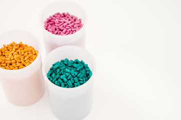 Plastic granules close up for holding,Colorful plastic granules with white background. and dollar money,Plastic Business,Plastic industry.
