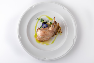 Baked tender juicy rabbit leg with celery. Banquet festive dishes. Gourmet restaurant menu. White background.