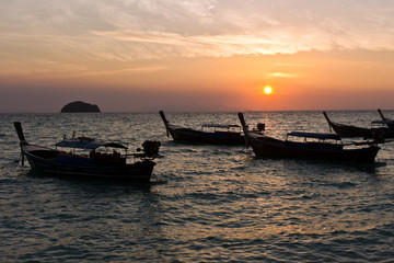 Fototapeta na wymiar Boats while Sunrise at Sunrise Beach, Koh Lipe, Thailand, Asia