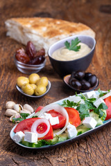 olives and hummus on dark wood