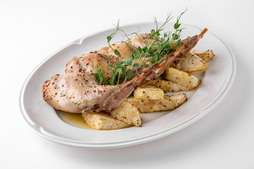 Baked tender juicy rabbit legs with celery. Banquet festive dishes. Gourmet restaurant menu. White...