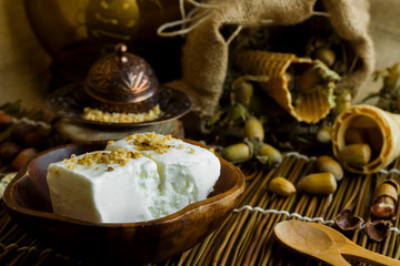 Vegan vanilla ice cream made with hazelnut milk in a bamboo cup, freshly minced hazelnuts