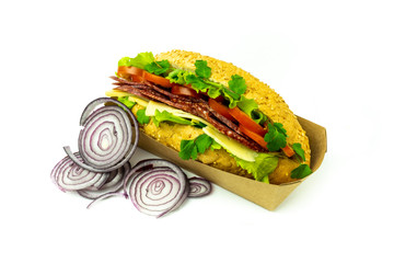 Delicious Sub deli sandwich baguette with ham, cheese, tomatoes and lettuce side view isolated on a white background