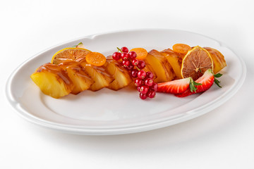 Dessert fried caramelized pineapple in own juice and berries. Banquet festive dishes. Gourmet restaurant menu. White background.