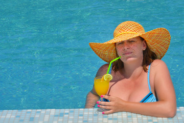 Real female beauty relaxing in swimming pool