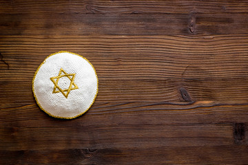 Jewish Kippah Yarmulkes hats with Star of David on wooden table. Religion Judaisim symbol. Top view, space for text