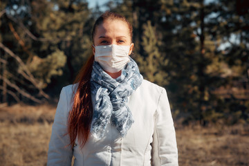 protection from diseases and coronavirus, a woman puts on a medical mask.