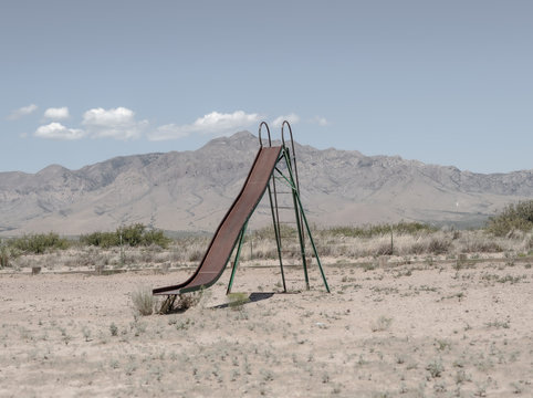 Rusty slide in desert playground.. Demming. Arizona. United States