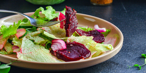 healthy salad beetroot slices, iceberg lettuce, greens. Menu concept food background, keto or paleo...