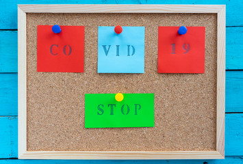 Cork board with caution message to fight covid-19