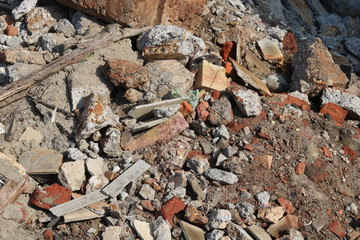 Construction waste with elements of and destroyed old structures at municipal landfill