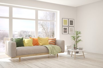 White living room with sofa and summer landscape in window. Scandinavian interior design. 3D illustration