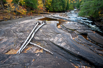 Low water levels on the Presque Isle River where it flow through the Porcupine Mountains Wilderness State Park exposes the nonesuch shale riverbed.