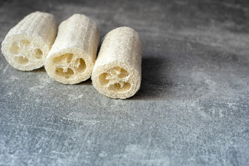 Luffa sponge for zero waste washing or bath on grey background. Eco bathroom accessories, zero...