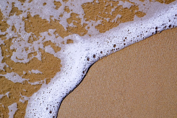 texture of sand and sea foam on the black sea beach, copy space