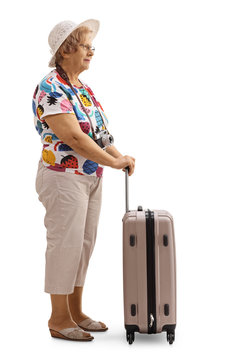 Senior female tourist with a suitcase