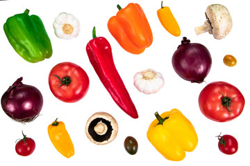 Composition with raw vegetables isolated on white. Different varieties of peppers, tomatoes, mushrooms, garlic and onion