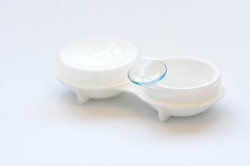 Contact lens on contact lens case on white background. Soft focus. Macro. Opthalmology and health concept