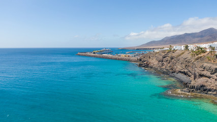 Obraz premium Morro Jable Canary Island, Fuerteventura Spain, Aerial view on coast of atlantic ocean and beach, Drone shot of sea 