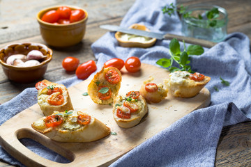 Baked toasts with garlic butter and tomatoes.