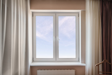 White window in the living room with sky
