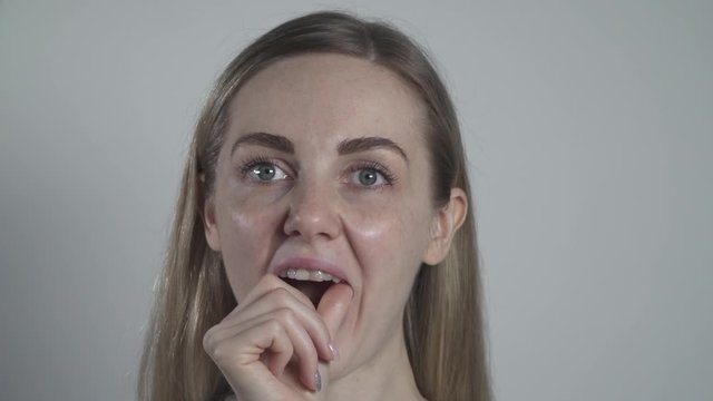 Young woman placing an occlusal bite splint into her mouth