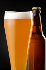 Bottle and glass of unfiltered wheat beer