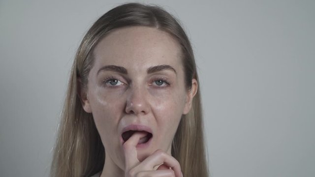 Young woman removes an occlusal bite splint from her mouth