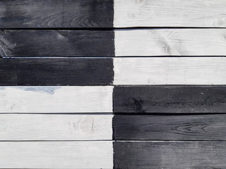 The shield of wooden boards is painted in black and white. Opposite and contrast.