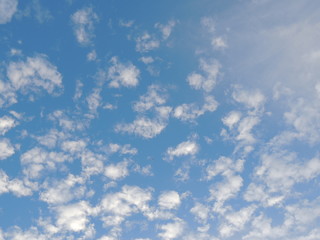 Cumulus and cirrus clouds on blue sky