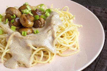 Spaghetti with mushrooms in cream sauce. on dark background