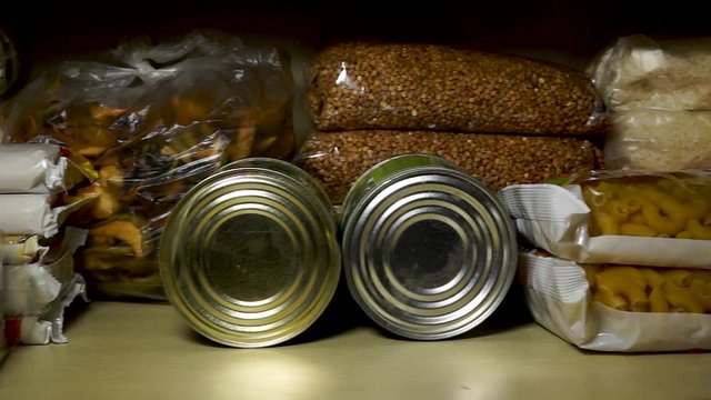 Stocks of cereals, sugar, pasta and canned goods on pantry shelf