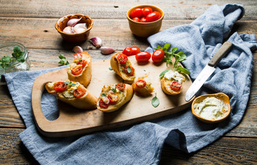 Baked toasts with garlic butter and tomatoes.