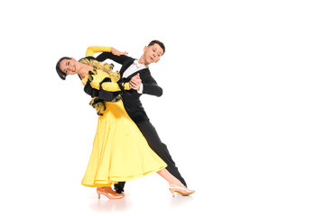 smiling elegant young couple of ballroom dancers in yellow dress and black suit dancing on white