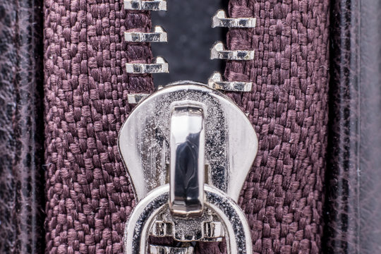 Fragment of a metal zipper close-up.