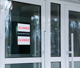 Entrance glass doors with the inscription Closed, quarantine. Stop coronavirus concept