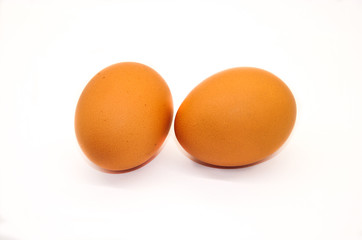  two chicken eggs on a white background