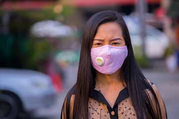Asian women wearing mask prevent, protection  Coronavirus, Covit-19 in the city blackground .