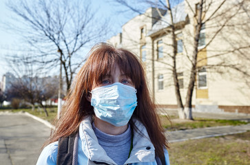 Woman wearing hygienic mask to prevent the Coronavirus. People in masks The outbreak of Novel...